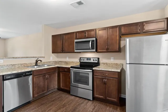 a kitchen with a sink a stove and refrigerator