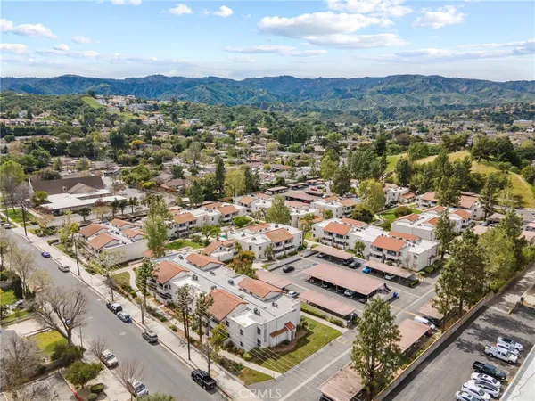 an aerial view of residential building with parking