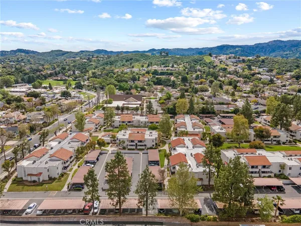 an aerial view of residential building with green space