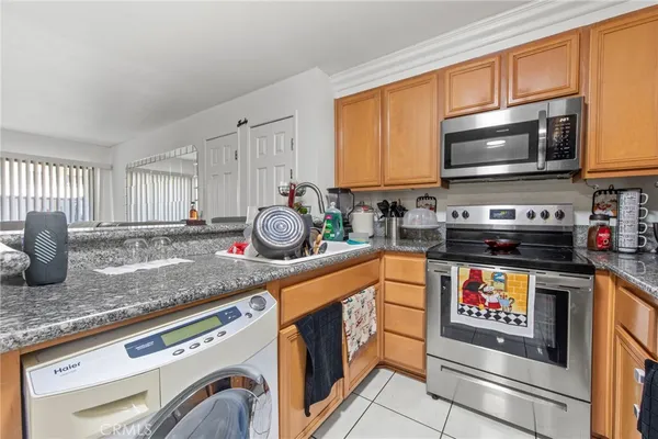 a kitchen with stainless steel appliances granite countertop a stove and a microwave