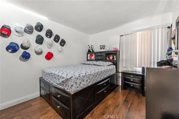 a bedroom with a bed and a dresser in it