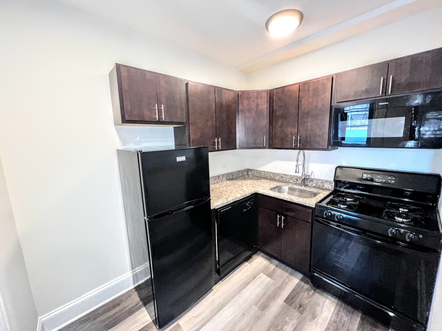 839 West Sheridan Road, Unit 204 Chicago, IL 60613 - Photo 10 of 13 a kitchen with a refrigerator and a stove top oven