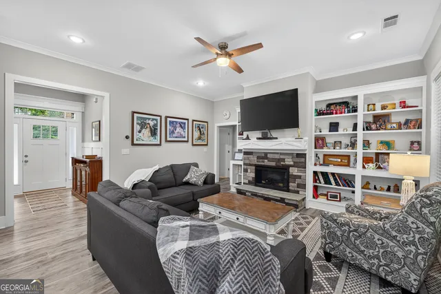 a living room with furniture and view of kitchen