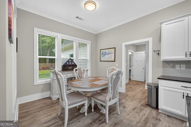 a view of a hallway with bathroom and wooden floor