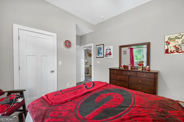 a view of a backyard with table and chairs and a barbeque