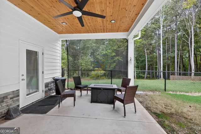 a front view of a house with a garden and trees