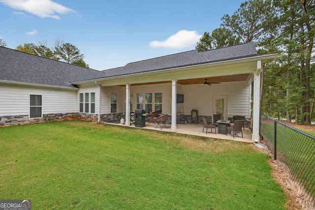 an aerial view of a house with swimming pool and garden