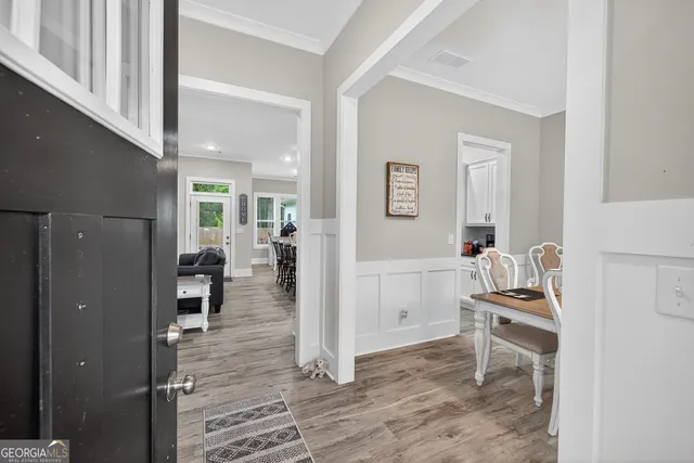 a view of a dining room with furniture and wooden floor