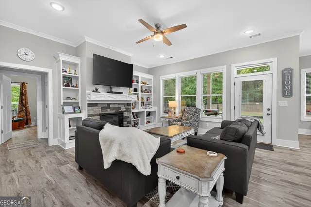 a living room with furniture a flat screen tv and a fireplace