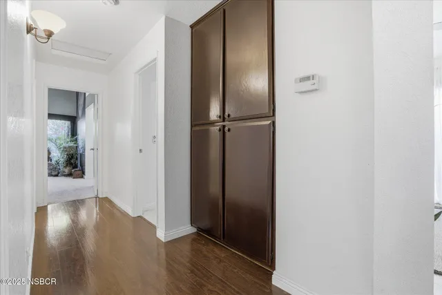 a view of a hallway with wooden floor