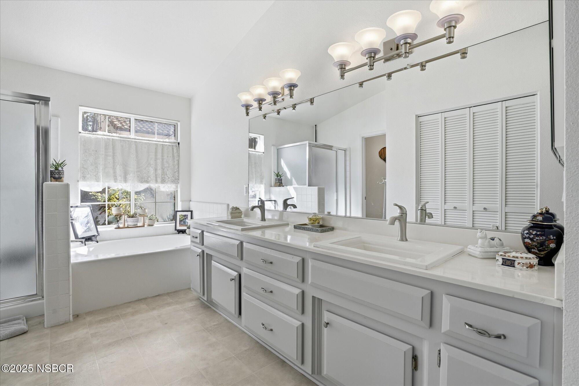 4300 Ridgecrest Street Santa Maria, CA 93455 - Photo 24 of 40 a spacious bathroom with a double vanity sink a mirror and a bathtub