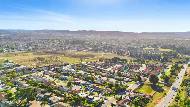 an aerial view of residential house with outdoor space and trees