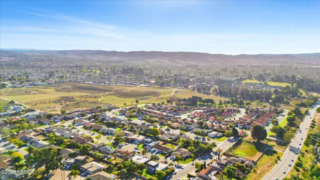 an aerial view of residential house with outdoor space and trees