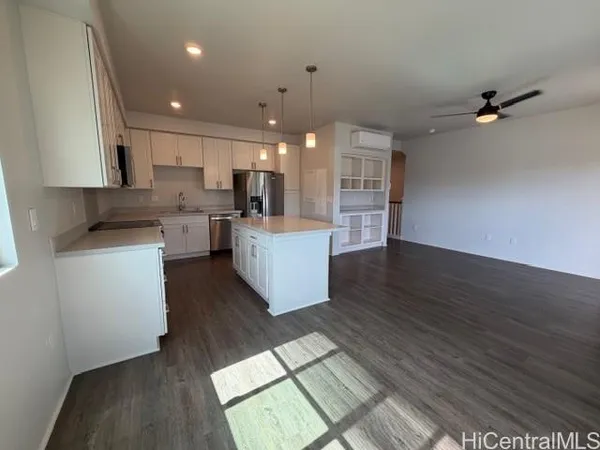 a large kitchen with cabinets a sink and appliances