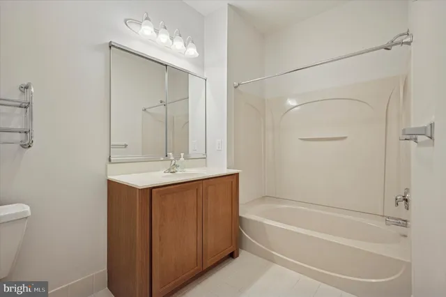 a bathroom with a bathtub a sink a toilet and a mirror