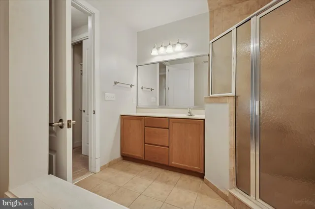 a bathroom with a granite countertop sink a mirror and a vanity