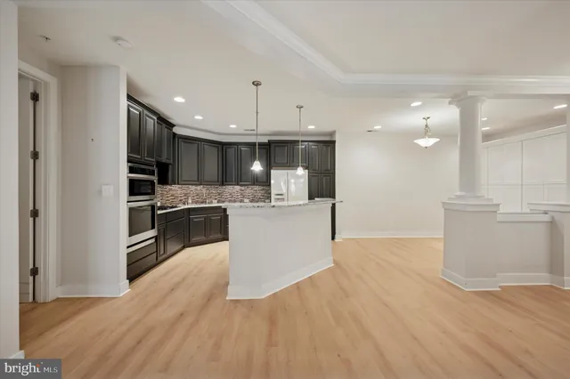 a large kitchen with kitchen island a sink stainless steel appliances and cabinets