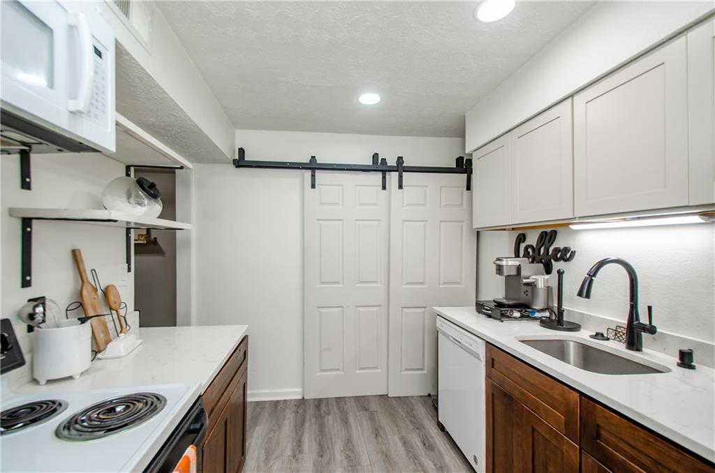 5157 Roswell Road, Unit 2 Atlanta, GA 30342 - Photo 15 of 24 a kitchen with a sink appliances and cabinets