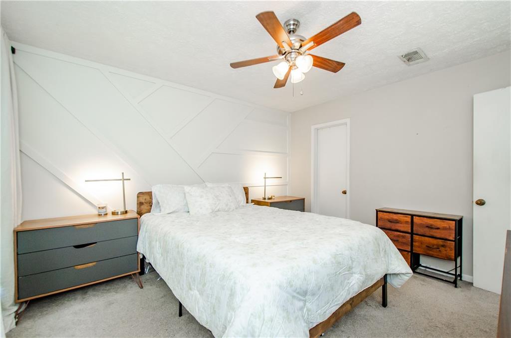 5157 Roswell Road, Unit 2 Atlanta, GA 30342 - Photo 19 of 24 a bedroom with a bed and a chandelier