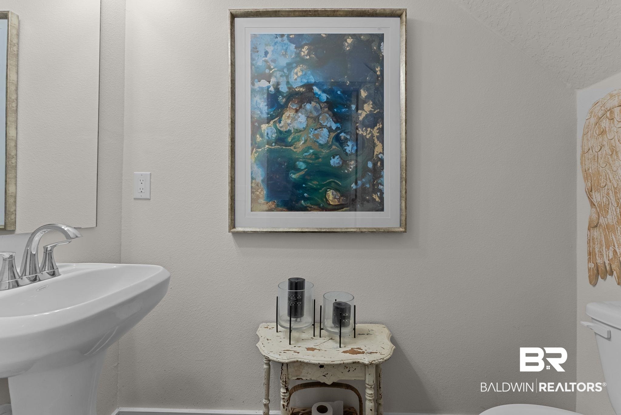 16607 Prado Loop Loxley, AL 36551 - Photo 36 of 46 Pedestal sink with chrome faucet and framed mirror
