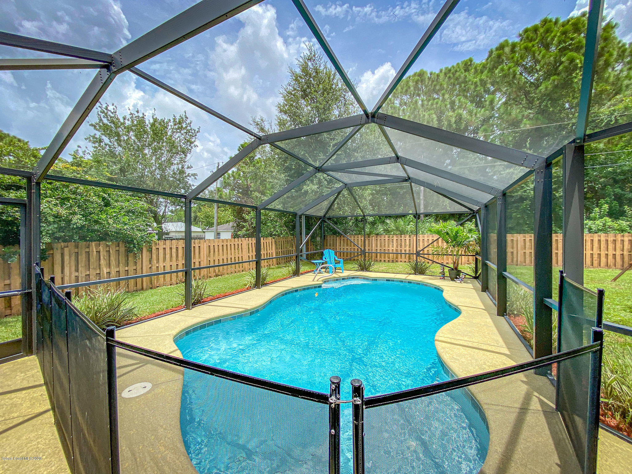 1253 Haulover Road Southwest Palm Bay, FL 32908 - Photo 11 of 52 a view of a patio with a table chairs and a table