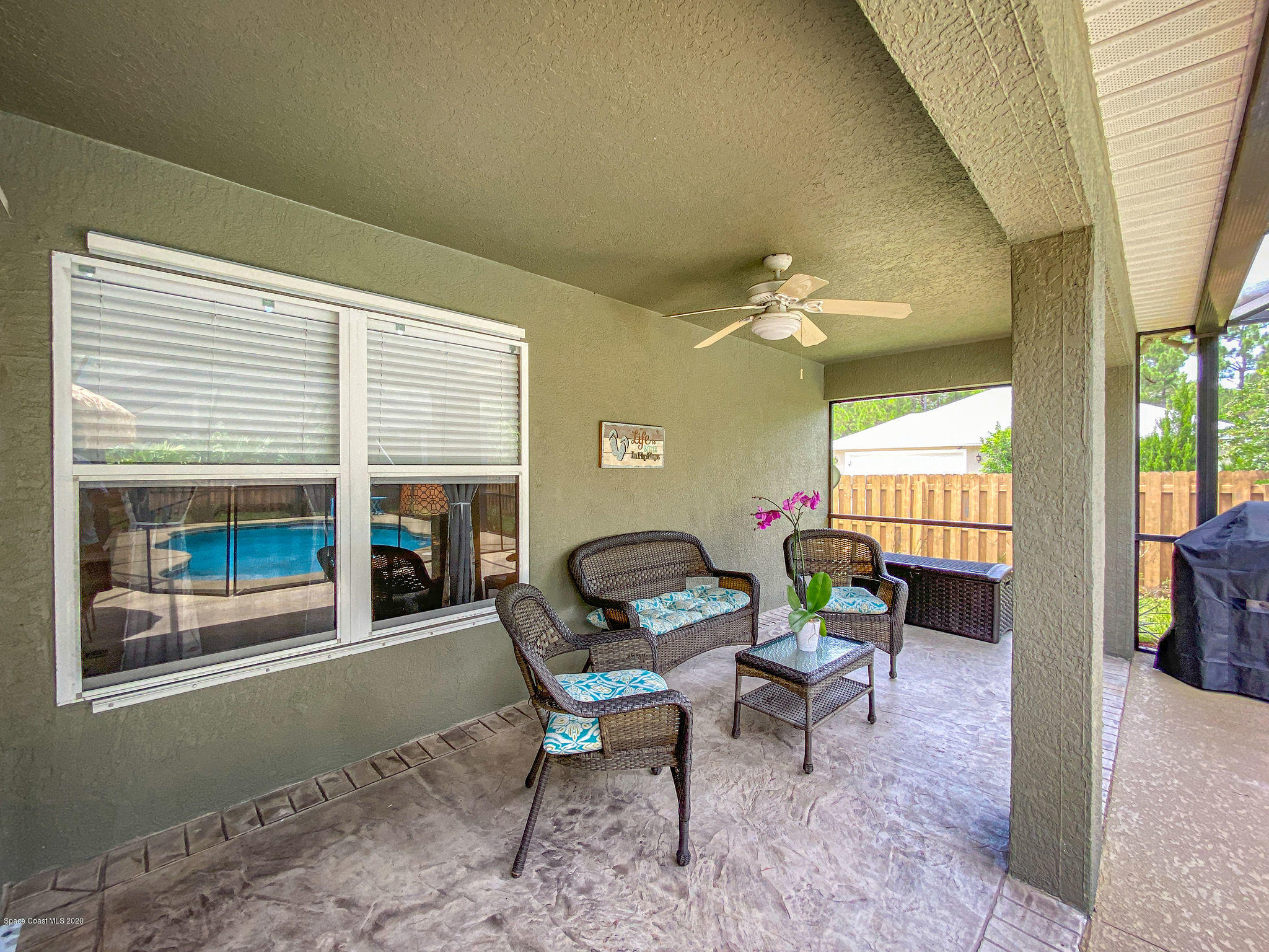 1253 Haulover Road Southwest Palm Bay, FL 32908 - Photo 13 of 52 a living room with furniture and a floor to ceiling window
