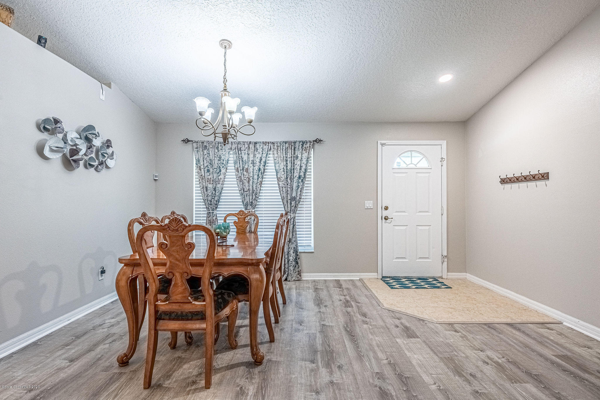 1253 Haulover Road Southwest Palm Bay, FL 32908 - Photo 18 of 52 a view of a dining room with furniture window and wooden floor