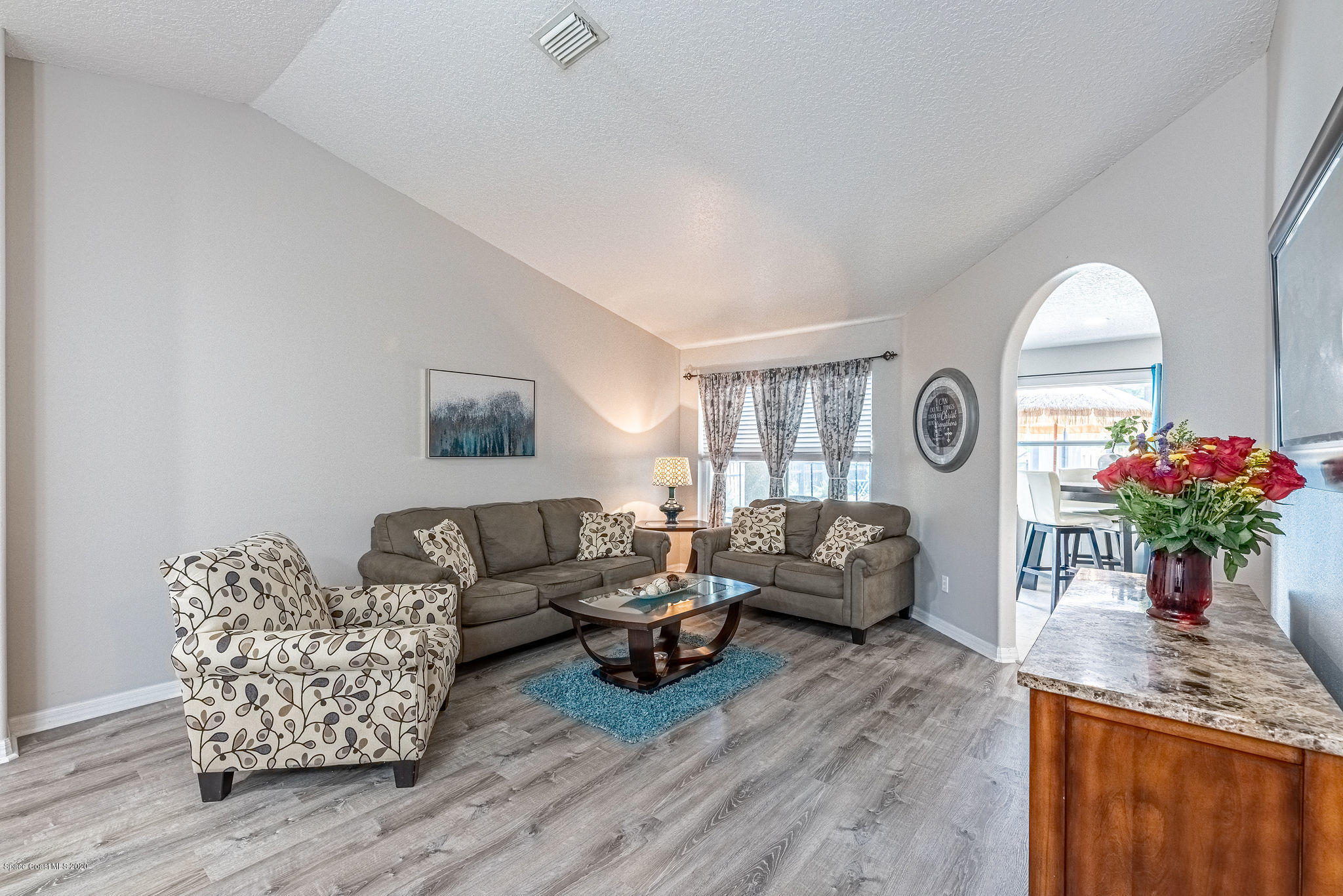 1253 Haulover Road Southwest Palm Bay, FL 32908 - Photo 19 of 52 a living room with furniture and a chandelier