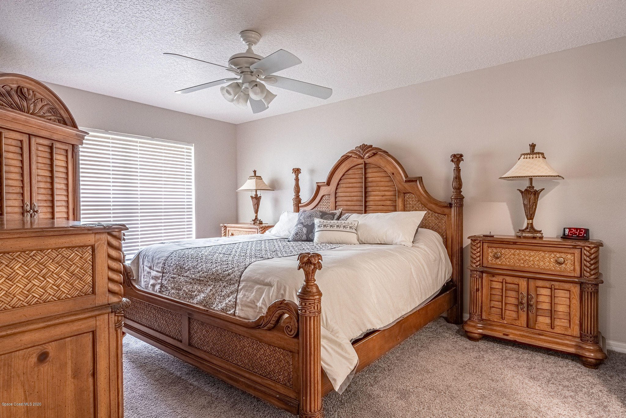 1253 Haulover Road Southwest Palm Bay, FL 32908 - Photo 20 of 52 a bedroom with a bed and a chandelier