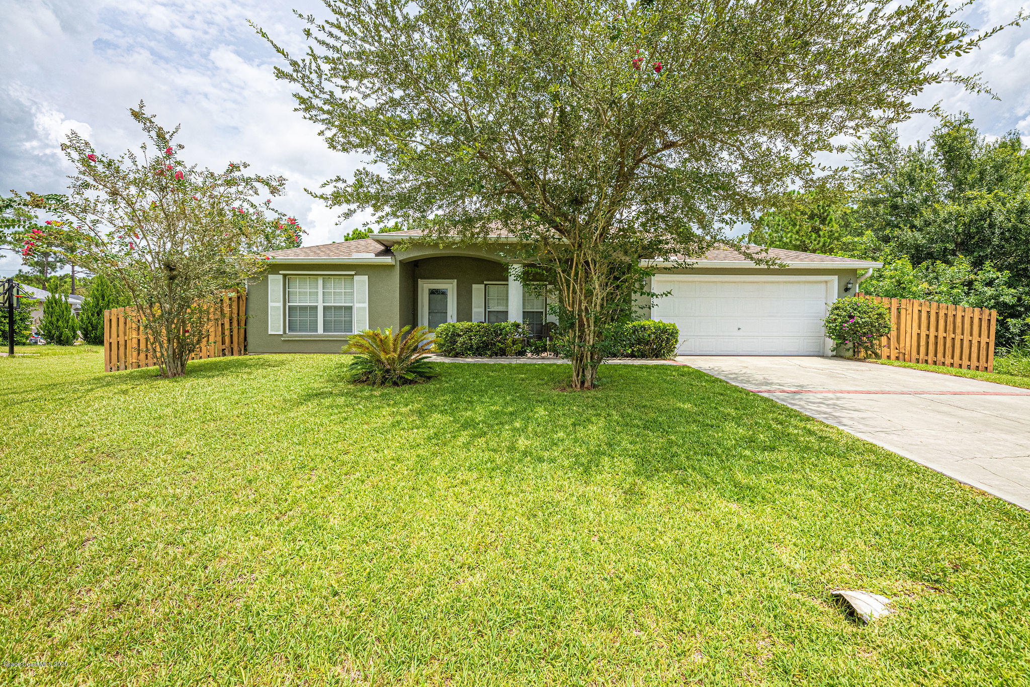 1253 Haulover Road Southwest Palm Bay, FL 32908 - Photo 3 of 52 a front view of house with yard and green space