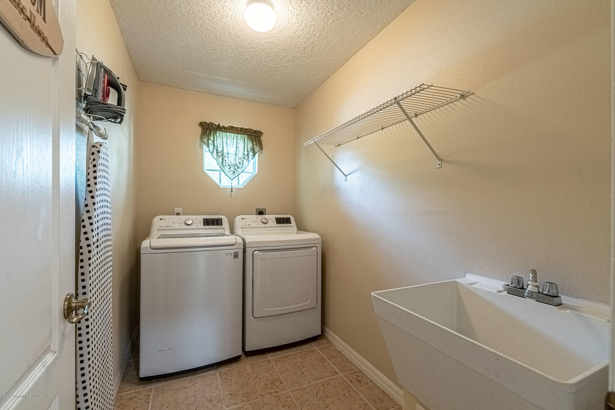 1253 Haulover Road Southwest Palm Bay, FL 32908 - Photo 24 of 52 a utility room with dryer and washer