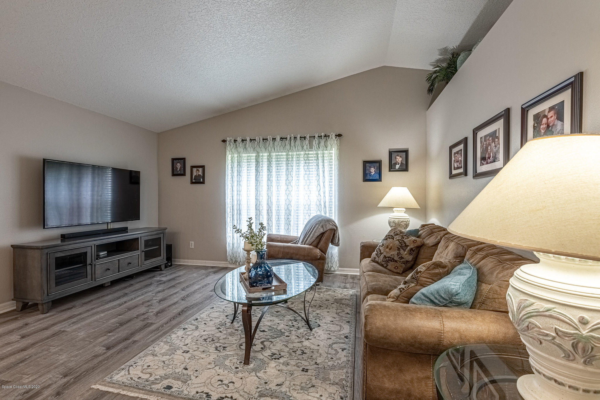 1253 Haulover Road Southwest Palm Bay, FL 32908 - Photo 32 of 52 a living room with furniture and a flat screen tv