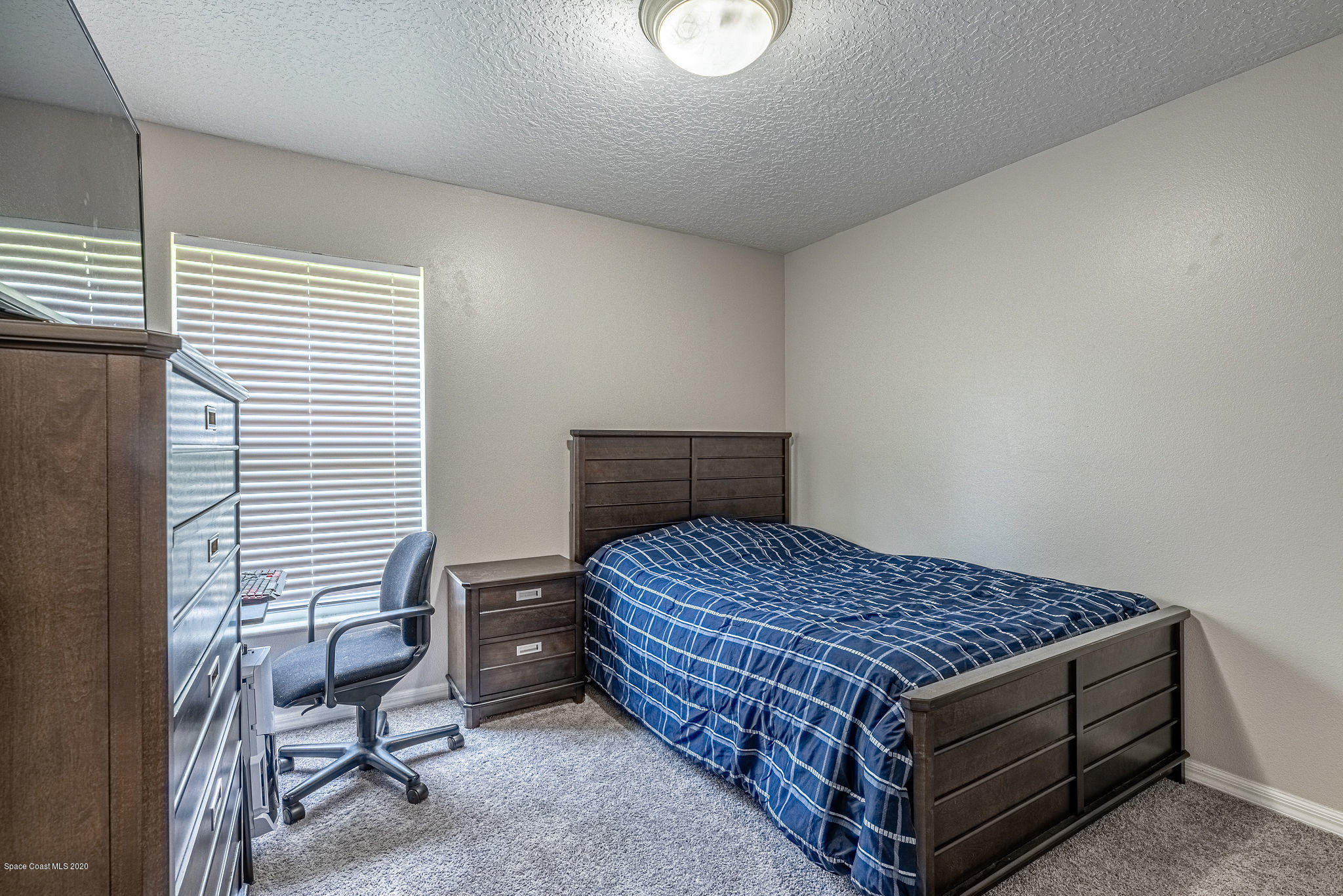 1253 Haulover Road Southwest Palm Bay, FL 32908 - Photo 33 of 52 a bed sitting in a bedroom next to a window