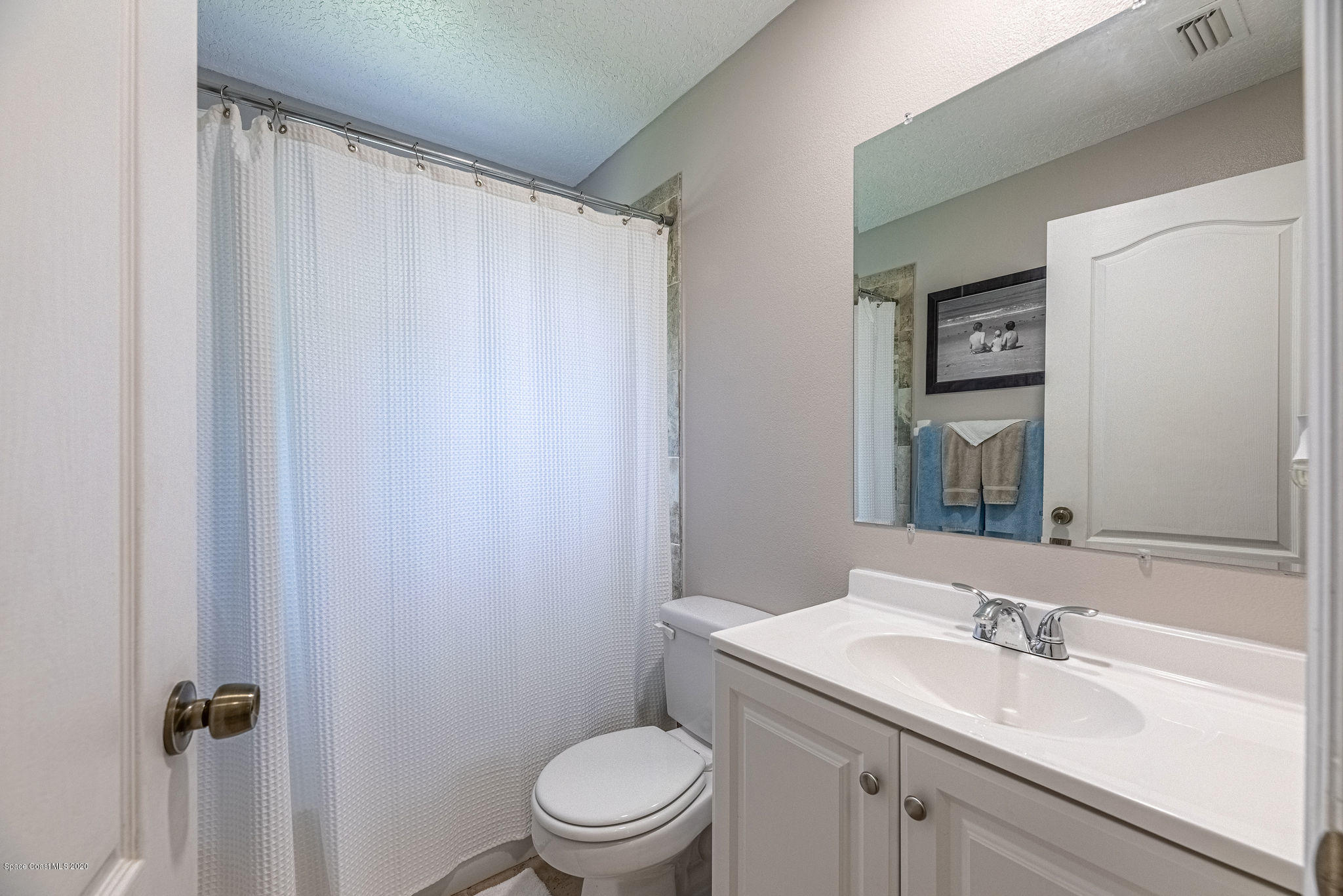 1253 Haulover Road Southwest Palm Bay, FL 32908 - Photo 35 of 52 a bathroom with a sink a toilet and shower