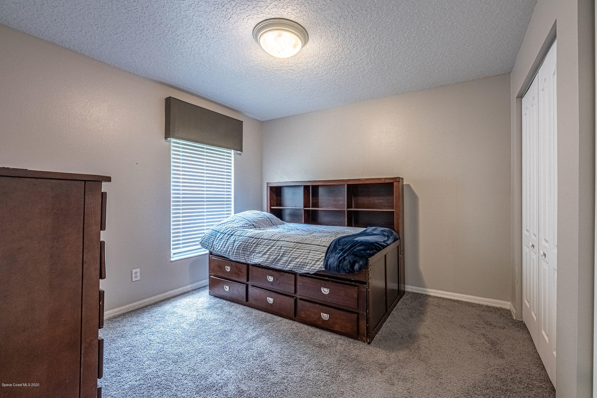 1253 Haulover Road Southwest Palm Bay, FL 32908 - Photo 36 of 52 a bedroom with a bed and a window