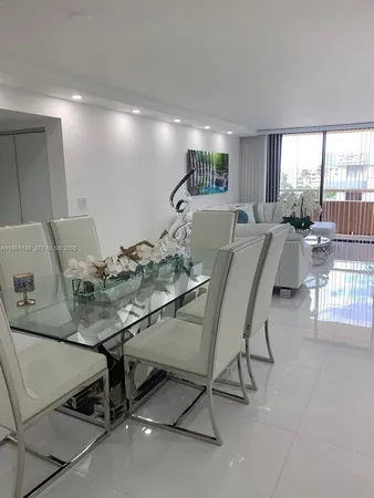 a view of a dining room with furniture and a floor to ceiling window