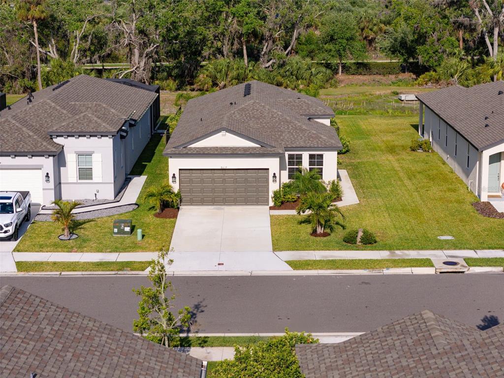 8619 Firefly Place Parrish, FL 34219 - Photo 1 of 1 an aerial view of a house with a yard and lake view