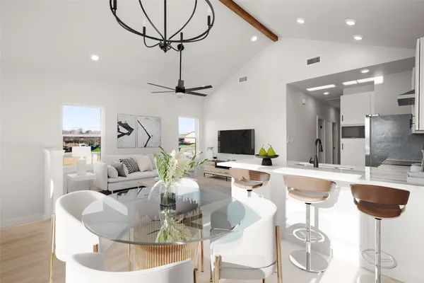 a living room with furniture a chandelier and a flat screen tv