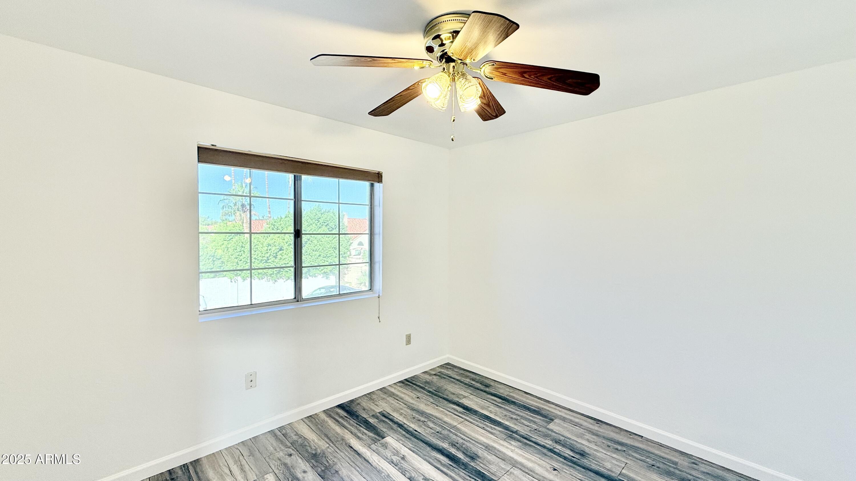 413 North Flint Street Gilbert, AZ 85234 - Photo 11 of 19 an empty room with a window and a ceiling fan