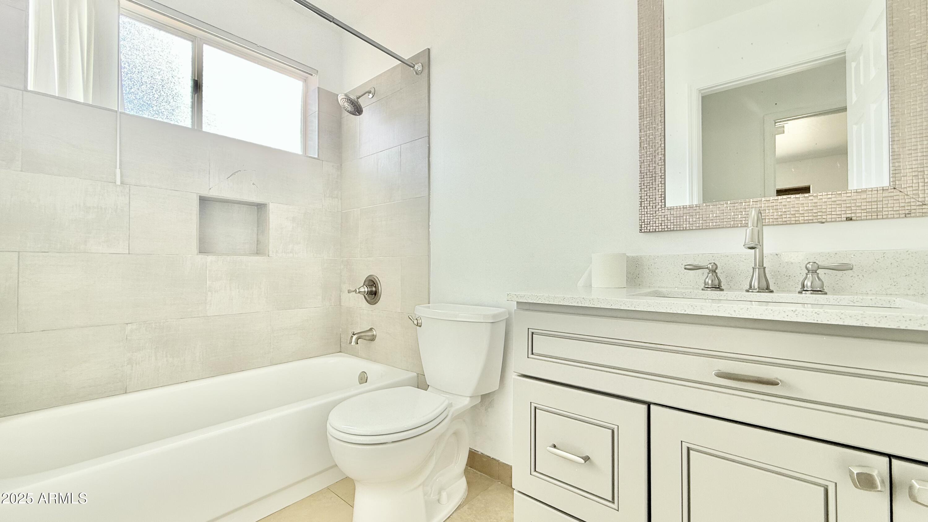 413 North Flint Street Gilbert, AZ 85234 - Photo 17 of 19 a bathroom with a sink a toilet and bathtub