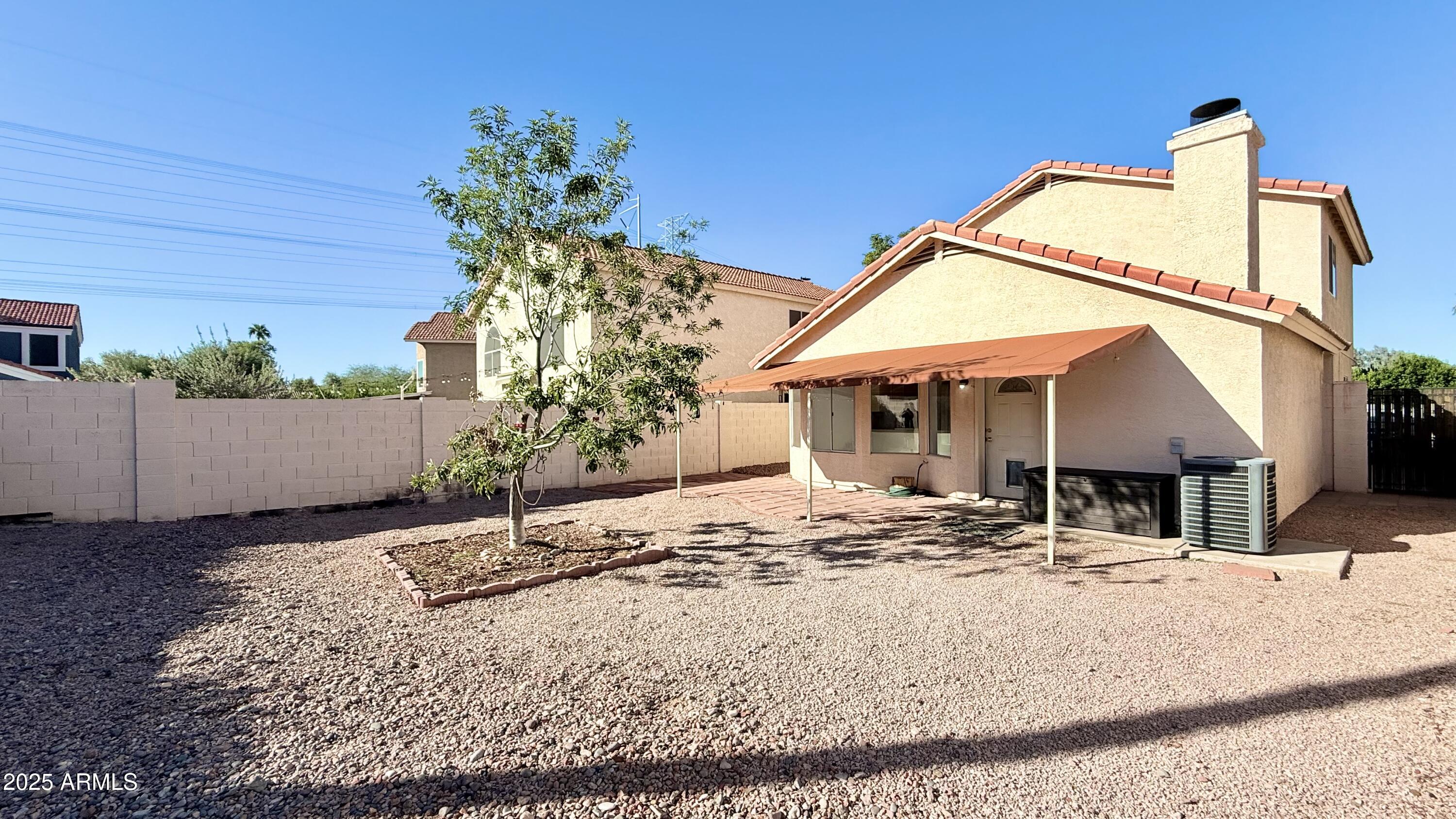 413 North Flint Street Gilbert, AZ 85234 - Photo 19 of 19 a view of a house with a snow on the road and covered with wooden fence