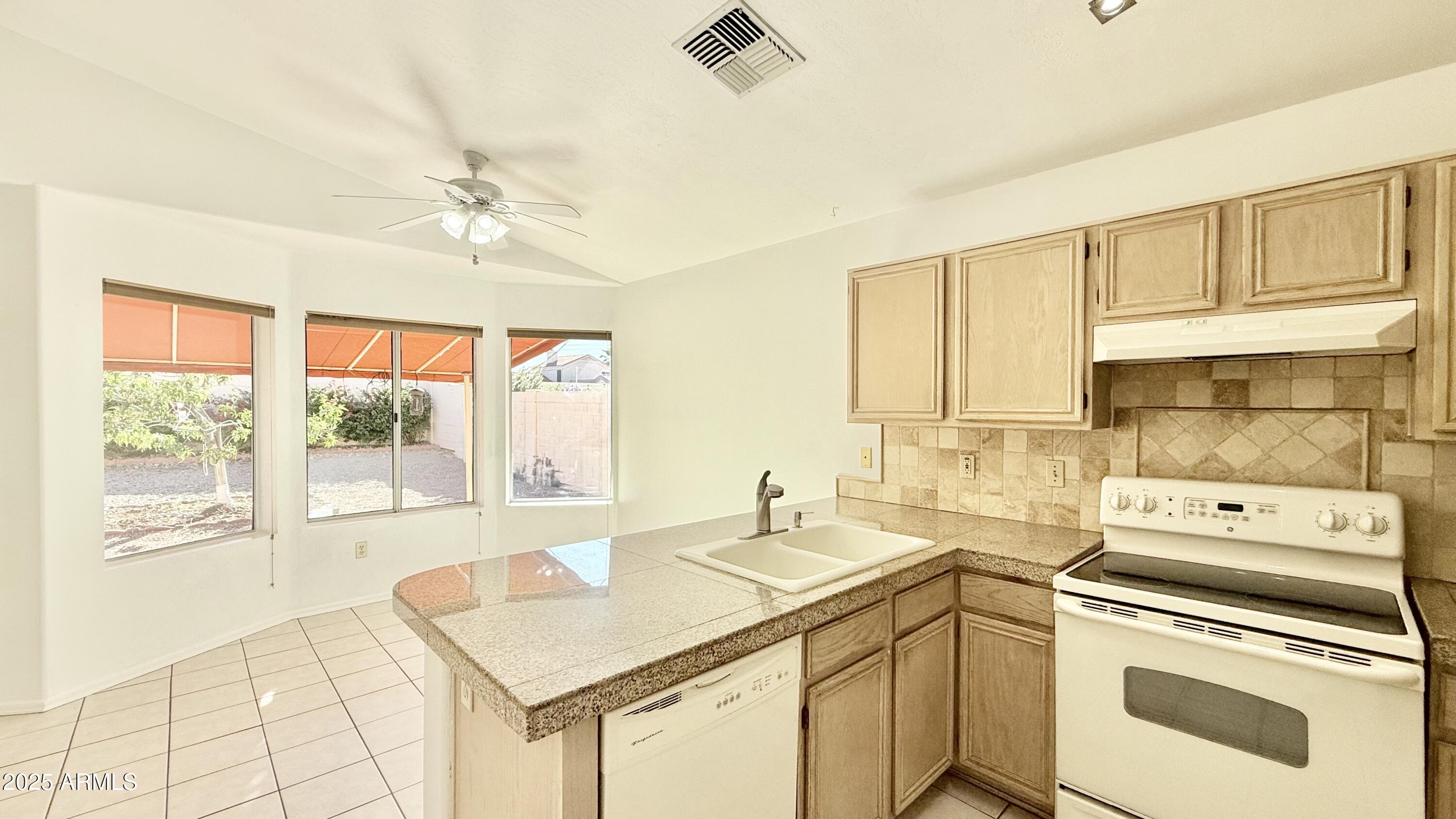 413 North Flint Street Gilbert, AZ 85234 - Photo 3 of 19 a kitchen that has a sink and a stove
