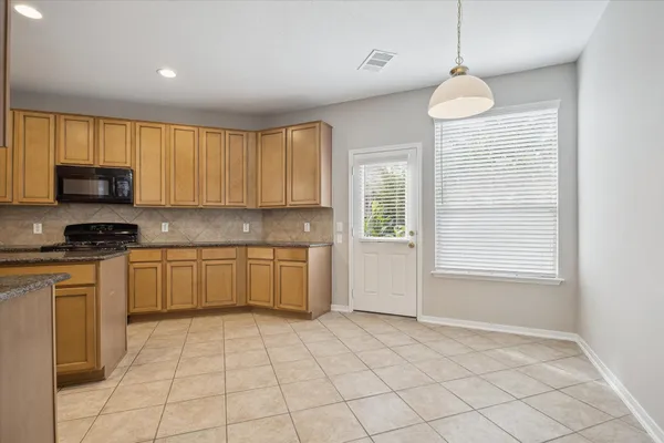 a kitchen with a stove a sink dishwasher and a refrigerator