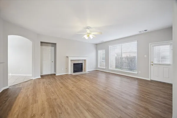 wooden floor fireplace and natural light in room