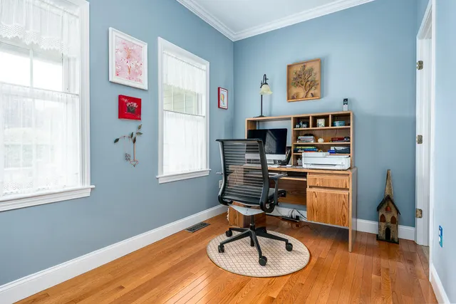 a workspace with furniture window and wooden floor