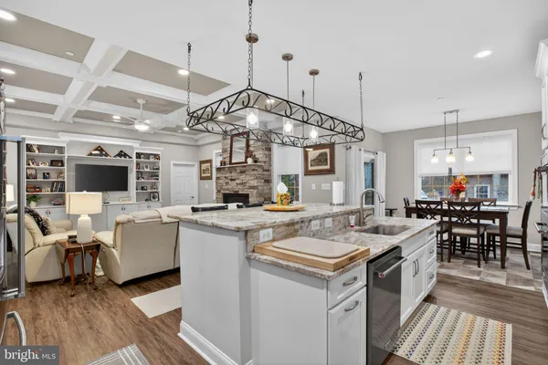 a open kitchen with stainless steel appliances granite countertop a stove and a refrigerator