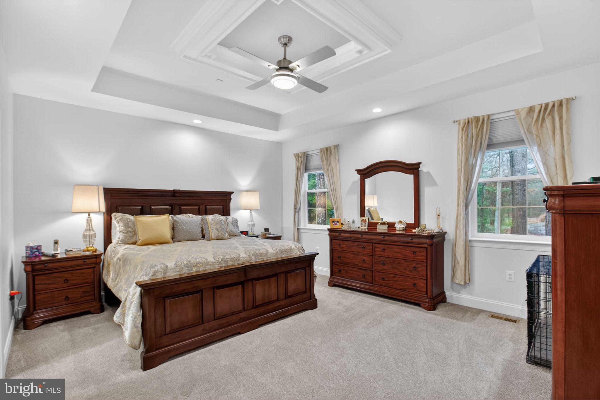 14730 Locust Court Swan Point, MD 20645 - Photo 19 of 38 a bedroom with a large bed and a large window