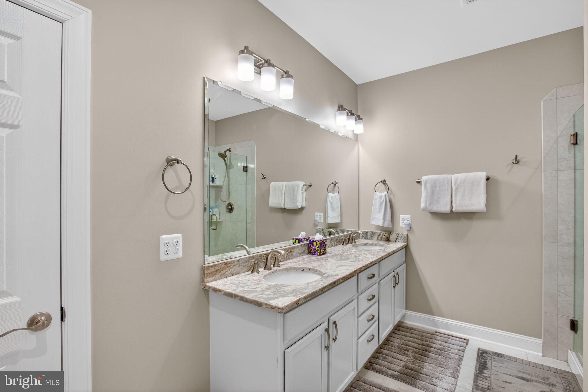 14730 Locust Court Swan Point, MD 20645 - Photo 25 of 38 a bathroom with a sink and a mirror