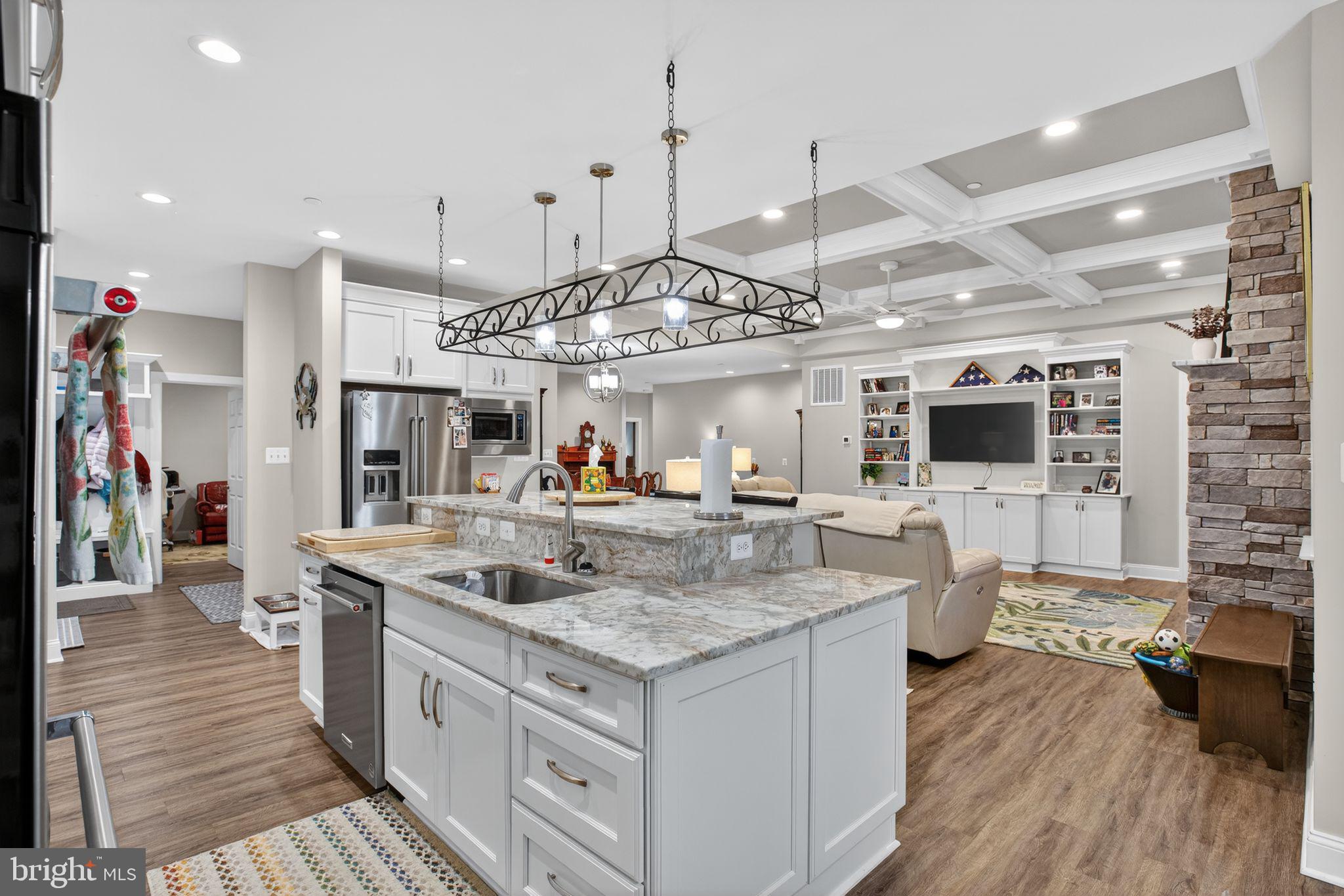 14730 Locust Court Swan Point, MD 20645 - Photo 5 of 30 a view of center island of a kitchen with granite countertop living room and stainless steel appliances
