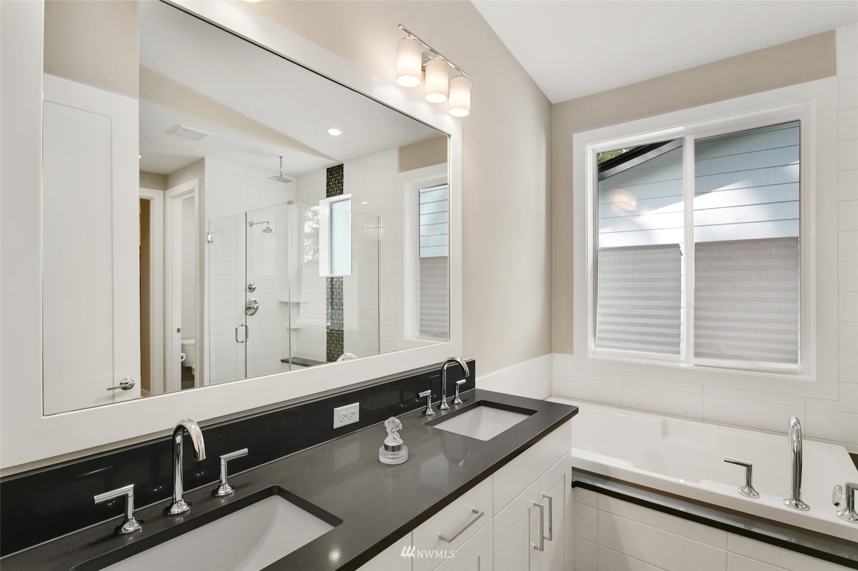 21899 Southeast 5th Place Sammamish, WA 98074 - Photo 23 of 35 a bathroom with a sink double vanity and a bathtub